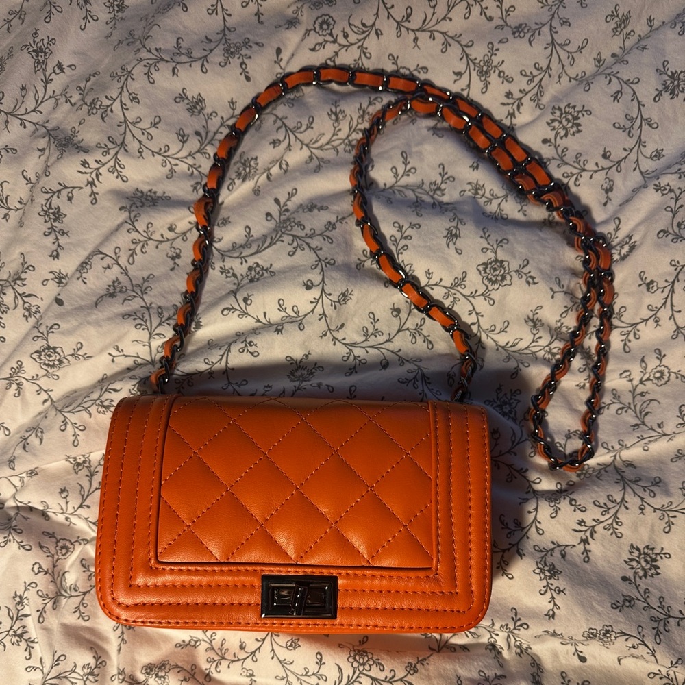 Orange faux leather purse crossbody with black chain strap perfect for nigh-outs